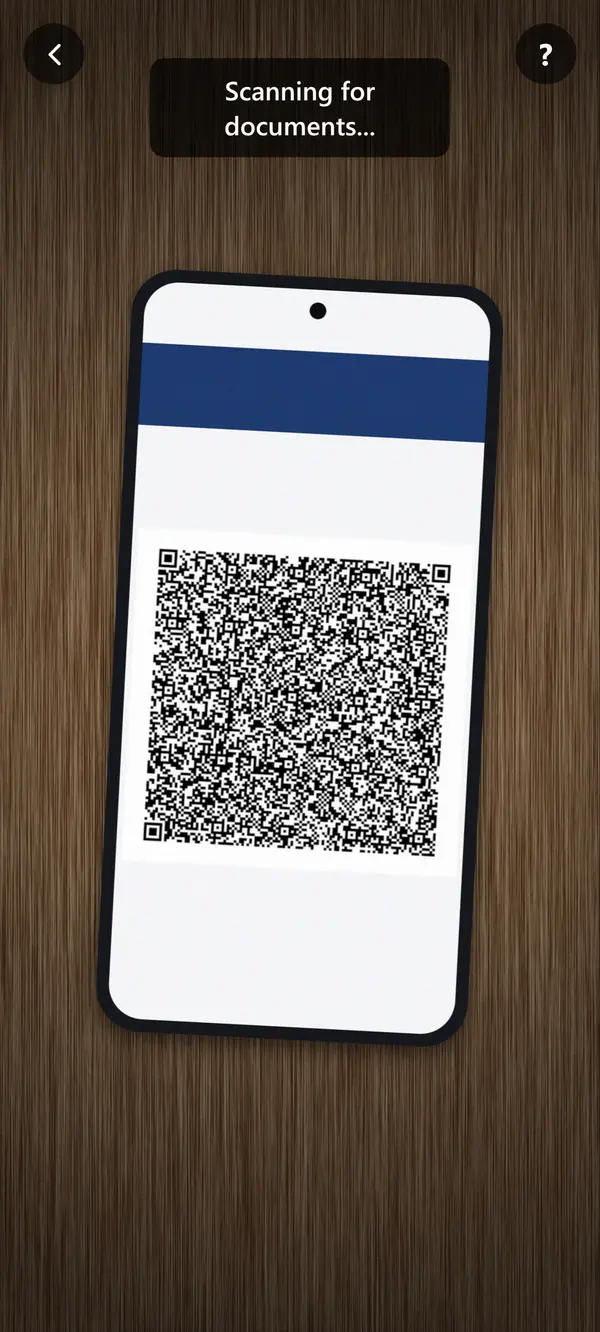 Camera open in portrait over a phone lying on a desk, its screen showing a large MiDNI QR code. Caption overlay: "Scanning for documents..."